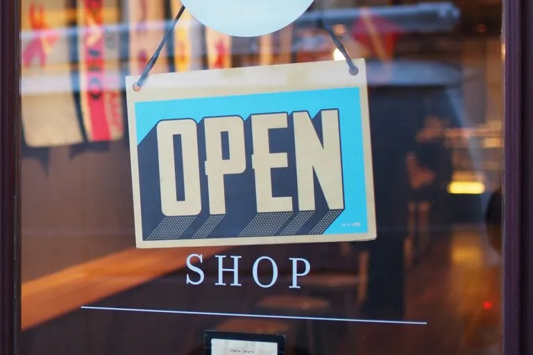 Creator managing an online shop for AI art sales with a branded storefront on screen